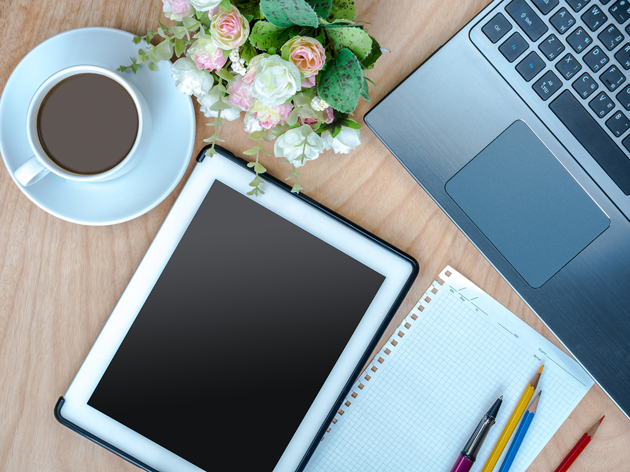 Worktable with laptop, tablet & cup of coffee