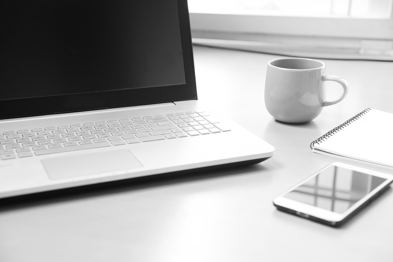 Desk table with a laptop and mobile phone