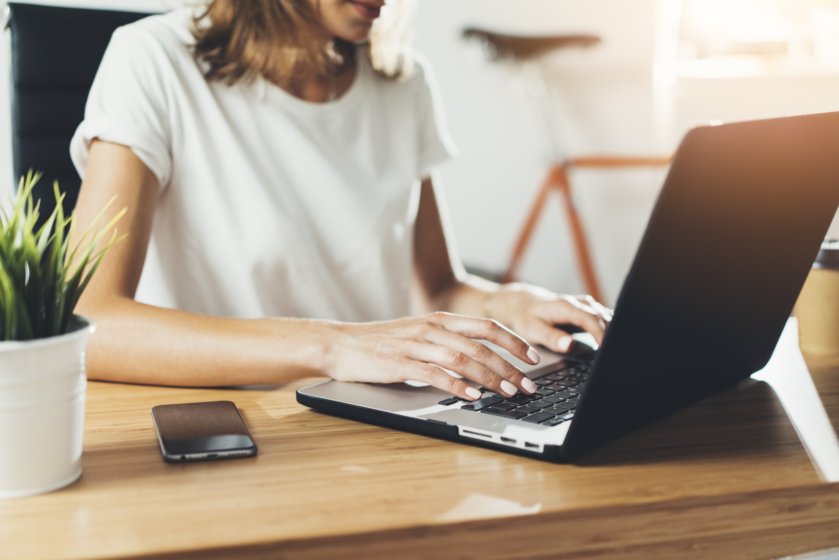 Woman typing on a laptop